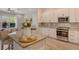 Modern kitchen featuring stainless steel appliances, granite counters, and light wood flooring at 5097 Faberge Pl, Sarasota, FL 34233