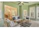 Inviting lanai featuring comfortable seating, a ceiling fan, and views of the garden at 5097 Faberge Pl, Sarasota, FL 34233