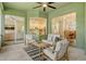 Relaxing screened-in lanai with comfortable seating, offering views of the garden and connecting to living spaces at 5097 Faberge Pl, Sarasota, FL 34233