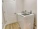 A well-lit laundry room features a washer, dryer, and tile floors at 5097 Faberge Pl, Sarasota, FL 34233