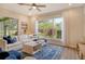 Comfortable living room with bright natural light, featuring a large sectional sofa and stylish rug at 5097 Faberge Pl, Sarasota, FL 34233
