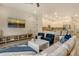 Cozy open-plan living room with modern decor, including a large TV and kitchen bar seating at 5097 Faberge Pl, Sarasota, FL 34233