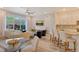Bright open-plan living room with modern furnishings and adjacent kitchen island seating at 5097 Faberge Pl, Sarasota, FL 34233