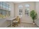 Bright office with three windows features neutral carpet, a desk, and gold accents at 5097 Faberge Pl, Sarasota, FL 34233