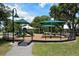 Well-maintained playground with multiple slides, swings, and shaded areas at 5097 Faberge Pl, Sarasota, FL 34233