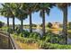 Scenic pond view with a fountain, surrounded by lush landscaping and residential homes at 5097 Faberge Pl, Sarasota, FL 34233