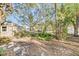 Wooded backyard with stone path at 514 Riverside E Dr, Bradenton, FL 34208