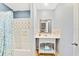 Bathroom with shower/tub combo, white vanity, and teal shower curtain at 514 Riverside E Dr, Bradenton, FL 34208