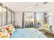 Bedroom with large windows, ceiling fan, and view of waterfront at 514 Riverside E Dr, Bradenton, FL 34208