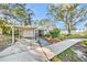 House exterior showcasing carport and a nicely landscaped front yard at 514 Riverside E Dr, Bradenton, FL 34208