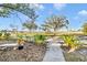 Landscaped front yard with waterfront view at 514 Riverside E Dr, Bradenton, FL 34208