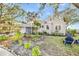 House exterior with lush landscaping and shaded backyard at 514 Riverside E Dr, Bradenton, FL 34208