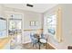 Eat-in kitchen with small table and chairs, plus view into adjacent dining area at 514 Riverside E Dr, Bradenton, FL 34208