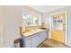Bright kitchen features wood countertops, light cabinets, and a charming yellow door at 514 Riverside E Dr, Bradenton, FL 34208