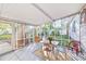 Screened porch with table and chairs, perfect for outdoor dining at 514 Riverside E Dr, Bradenton, FL 34208