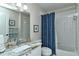 Clean bathroom with tub and blue shower curtain at 5261 Mahogany Run Ave # 624, Sarasota, FL 34241