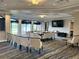 Elegant community room features a large table, comfortable chairs, and big screen TV at 5261 Mahogany Run Ave # 624, Sarasota, FL 34241