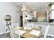 Charming dining area with an elegant chandelier and a view of the kitchen at 5261 Mahogany Run Ave # 624, Sarasota, FL 34241