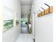 Bright entryway with view to living room and coat rack at 5261 Mahogany Run Ave # 624, Sarasota, FL 34241