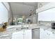 Kitchen with granite countertops, stainless steel appliances, and a view of the dining area at 5261 Mahogany Run Ave # 624, Sarasota, FL 34241