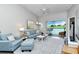 Bright living room with comfy sofas, a view of the golf course and access to a balcony at 5261 Mahogany Run Ave # 624, Sarasota, FL 34241