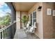 Cozy screened balcony with seating and plants at 5261 Mahogany Run Ave # 624, Sarasota, FL 34241