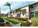 Condo building with palm trees, landscaping, and walkway at 5281 Mahogany Run Ave # 822, Sarasota, FL 34241