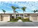 Condo building exterior with palm trees and landscaping at 5281 Mahogany Run Ave # 822, Sarasota, FL 34241