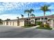 Condo building showcasing multiple garages and landscaping at 5281 Mahogany Run Ave # 822, Sarasota, FL 34241