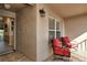 Cozy screened porch with red chairs and view of landscaping at 5281 Mahogany Run Ave # 822, Sarasota, FL 34241