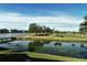 Serene water view of the golf course and lake at 5281 Mahogany Run Ave # 822, Sarasota, FL 34241