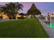 Spacious backyard with patio, lush landscaping, and waterfront access at 536 Ketch Ln, Longboat Key, FL 34228