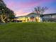 Spacious backyard with lush lawn and view of the house at 536 Ketch Ln, Longboat Key, FL 34228