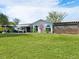 Large backyard with lush grass and modern house view at 536 Ketch Ln, Longboat Key, FL 34228
