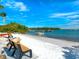 Scenic beach view with boats and benches under clear sky at 536 Ketch Ln, Longboat Key, FL 34228