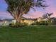 Stunning home exterior at dusk, with lush landscaping at 536 Ketch Ln, Longboat Key, FL 34228