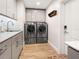 Modern laundry room with washer, dryer, and cabinets at 536 Ketch Ln, Longboat Key, FL 34228