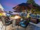 Cozy patio with fire pit and comfortable wicker seating at 536 Ketch Ln, Longboat Key, FL 34228