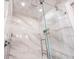 Large walk-in shower with marble walls and glass enclosure at 536 Ketch Ln, Longboat Key, FL 34228