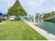 Peaceful waterfront view with lush green grass and dock at 536 Ketch Ln, Longboat Key, FL 34228