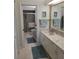 Bright bathroom with double vanity, shower, and updated fixtures at 5492 Hampstead Heath # 11, Sarasota, FL 34235