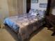 Guest bedroom with a comfortable bed and built-in shelving at 5492 Hampstead Heath # 11, Sarasota, FL 34235