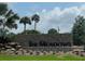 The Meadows community entrance with stonework and landscaping at 5492 Hampstead Heath # 11, Sarasota, FL 34235