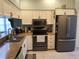 Modern kitchen with stainless steel appliances and light cabinets at 5492 Hampstead Heath # 11, Sarasota, FL 34235