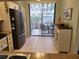 Kitchen with stainless steel appliances and patio access at 5492 Hampstead Heath # 11, Sarasota, FL 34235