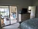 Main bedroom with access to the patio and a dresser at 5492 Hampstead Heath # 11, Sarasota, FL 34235