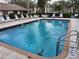 Inviting community pool with plenty of lounge chairs at 5492 Hampstead Heath # 11, Sarasota, FL 34235