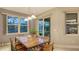 Casual dining area with wooden table and chairs, overlooking the pool at 5601 Long Shore Loop, Sarasota, FL 34238