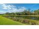 Serene pond view with lush vegetation at 5601 Long Shore Loop, Sarasota, FL 34238