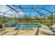 Screened pool and patio overlooking a pond at 5601 Long Shore Loop, Sarasota, FL 34238